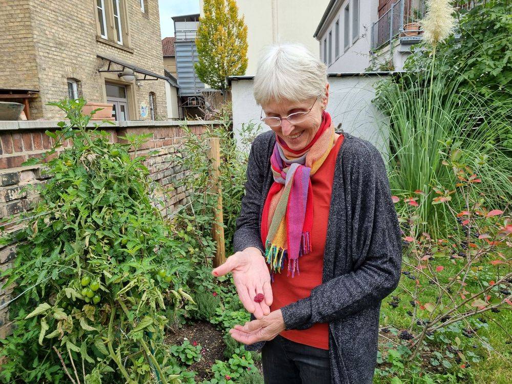Frau mit Himbeere in der Hand
